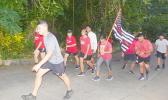Members of the community march to honor fallen firefighters
