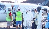 Ground crew and medical personnel on the tarmac at the Pago Pago International Airport 