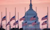 U.S. Capital building with flags at half staff