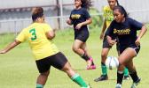 A Cougars player (right) dribbling away from a Leone defender during