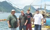 The two local businessmen who worked together to pull up the sunken Fo’isia vessel yesterday at the Malaloa Marina: (l-r) Iupeli Kava and Timothy Jones Sr., together with Timothy Jones Jr., and a bystander. The government owned Fo'isia sank - for reasons unknown - earlier this year in May. [photo: AF]