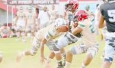 Scott Pese is brought down by two Team Fealofani defenders