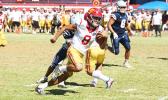 Tafuna Warriors quarterback Oakland Salave’a scrambling through midfield 