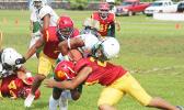 Joshua Taani of the Leone Lions is met by a Tafuna Warrior defender