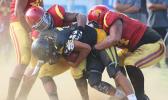 Nu’uuli Wildcats quarterback Nathaniel Maea is swallowed in the backfield for a loss by