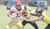 Tafuna’s ball carrier trying to evade the pressure from two Nu’uuli Wildcat defenders