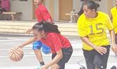 Dorvida Fuiava dribbling away as Leata Seumanu tries to stop her during a match-up between the yellow team and red team at last Saturday's basketball showdown in Malaeimi. [Courtesy photo]