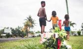 YOUNG LIFE LOST: Village children walk past a cross planted at Faleula to honour the memory of Vaialofa Loimata who was killed during the incident. Photo: Misiona Simo. Village children walk past a cross planted at Faleula