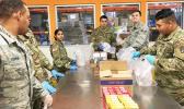 New York Army and Air National Guardsmen pack food parcels at Feeding Westchester, a food pantry in Westchester County, N.Y.