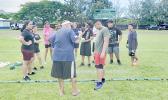 Coach CJ Sagapolutele Floor instructing Pacific Horizons School students