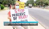 Demonstrators with signs in Waikiki waving to traffic
