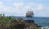 This Samoa News photo on Saturday morning, Apr. 21, 2018, shows the vessel, CS Responder, laying the undersea fiber optical cable for Hawaiki Submarine Cable LP, anchored off Fogagogo. Crew on two small boats are seen on the ocean, as VIPs and guests gathered on Fogagogo the high rocky shoreline area - close to the airport runway - to witness the Hawaiki cable landing.  [photo: FS]
