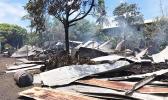 roofing iron smoldering and spread around on the ground