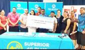 U.T.O.S/BLUESKY: Staff members of U.T.O.S and Bluesky with the $1million cheque.