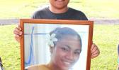 Eleven-year-old Malakai, posing for Samoa News with a portrait of his mother, Sabrina Seva’aetasi