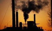  Smoke billows from a chimney of the Solvay factory for production and processing of plastic materials, in Ospiate, near Milan, Italy, Friday, Dec. 14, 2018