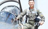 2nd LT Hanyoun Ao Jeong stepping into the cockpit of a jet airplane