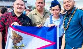 Kathlynn Faaita with family holding an American Samoa flag