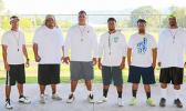 Lions coaching staff led by Head Coach Okland Salave'a (center) posing for a group photo just before practice. Salave’a is the former head coach for the Tafuna High School football program — leading them to a ‘3-peat’ football championship, a THS record. However, last year, the Vikings defeated the Warriors stopping THS’ dreams of a 4-peat record.  [photo: TG]