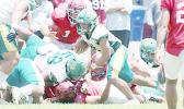 Leone Lions running back Wylan Faga avoids a pile-up and continues to run
