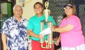 Pisita Lui of Lion Heart’s Girls 13-15 team receives the championship trophy