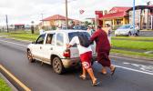 American Samoa Lieutenant Governor Lemanu pushing stalled car out of the way of traffic