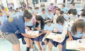 Manumalo Academy 3rd graders look through their new dictionaries