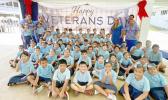 Manumalo students in front of their Veterans Day banner