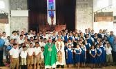 Most Reverend Bishop Peter Hugh Brown (front, center) who is pictured with St. Theresa Elementary School chaplain, Reverend Father Kolio Etuale; St. Theresa Elementary School principal Victor Langkilde (far left), staff members and students.