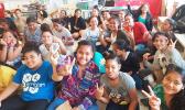 Some Level 7-8 students of Matafao Elementary School smile and wave to the camera