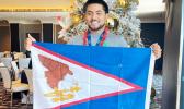 Mataio Suluai carrying the American Samoan flag
