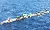 The Matasaua crew awaiting help to arrive after their fautasi took on water last Saturday