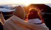 A couple watches as the sun rises in front of the summit of Haleakala volcano in Haleakala National Park on Hawaii's island of Maui, Sunday, Jan. 22, 2017. Sunrise viewing has long been popular at Haleakala, one of the main attractions at Haleakala National Park despite morning temperatures that often dip into the 30s. (AP Photo/Caleb Jones) A couple watches as the sun rises in front of the summit of Haleakala volcano in Haleakala National Park on Hawaii's island of Maui, Sunday, Jan. 22, 2017. Sunrise viewing has long been popular at Haleakala, one of the main attractions at Haleakala National Park despite morning temperatures that often dip into the 30s. (AP Photo/Caleb Jones)
