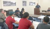 US Coast Guard Lt. Creighton C. Chong at the podium.