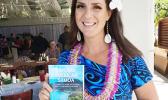 Melinda Laura Clayville holding the guidebook 