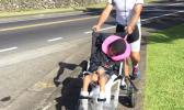 Matt Bracken, who took home second place during Saturday's Triathlon Olympic Division, is seen pushing Miracle, one of the Special Olympians on a stroller during the running portion of the competition.  [photo: Mark Espiritu]
