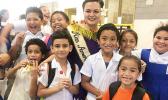 Reigning Miss American Samoa, Magalita Johnson with students.