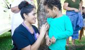 Fonoifafo Seumanu administering am MMR shot to a child