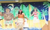 American Samoa’s very own “Moana” — standing in front of classroom doors painted with the likeness of Disney’s Maui and Moana