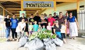 Faculty and parents of Fatuoaiga Montessori School pose for a photo after an hour of picking up trash