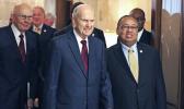 In this May 17, 2018 file photo, Mormon church President Russell M. Nelson, center, and Leon W. Russell, chairman of the NAACP board of directors, right, walk into a news conference, in Salt Lake City. The Mormon church on Friday, June 1, 2018, will celebrate the 40th anniversary of reversing its ban on black people serving in the lay priesthood, going on missions or getting married in temples, rekindling debate about one of the faith’s most sensitive topics. (AP Photo/Rick Bowmer, File)