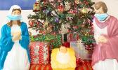 Nativity Scene in front of a Christmas Tree