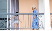 A woman and a young child on a balcony at Tradewinds Hotel