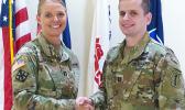Cpt. Carneen Cotton (left) shaking hands with Capt. Timothy Shea