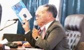  Samana Semo Ve’ave’a holds up for visual display the NOAA weather radio,