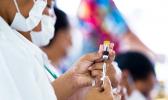 Nurse April Wilson (L) and team leader Luisa Popo preparing vaccinations