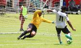 Maro Bonsu-Maro charging up for his third goal of the match as Veitongo FC goalie Sione Uhatahi reacts to defend a hat-trick that came in the second half of their 9-2 victory over Tonga this past Tuesday. All tourney games are played at the Pago Soccer Field. [photo: TG]