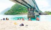 People swimming and relaxing under the Asaga Bridge