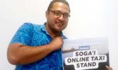  Dr. Kapuana Ainuu holding Soga'i Online Taxi Stand sign