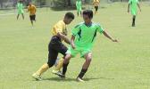 A Pago Youth players tries to dribble away from a Taputimu player